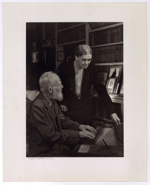 Portrait of George Bernard Shaw playing the spinet with Blanche …